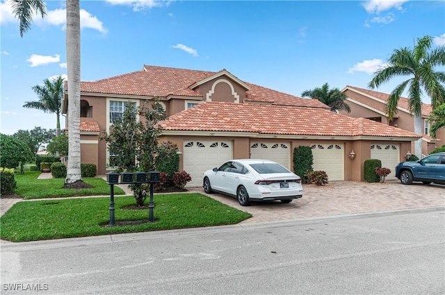 view of front facade featuring a front yard and a garage