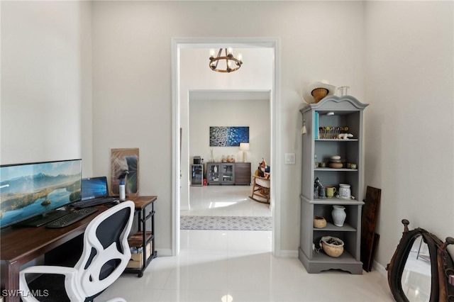 tiled office space with a chandelier