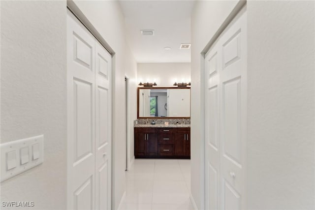 hallway with light tile patterned flooring