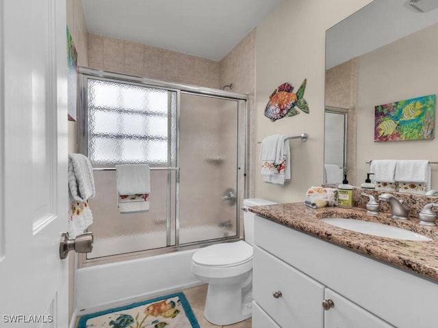 full bathroom featuring tile patterned flooring, vanity, toilet, and enclosed tub / shower combo