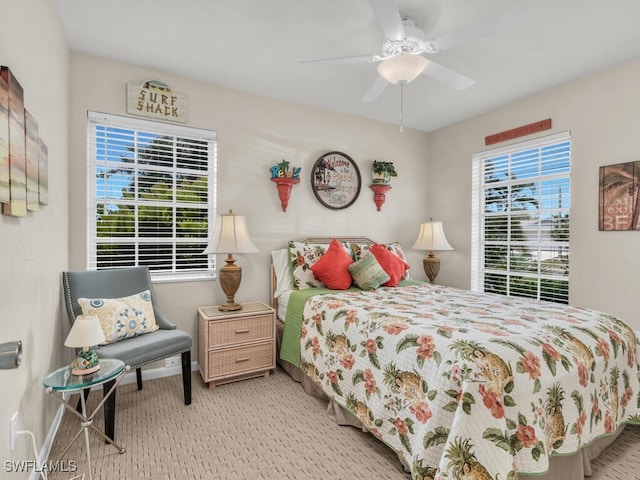 bedroom featuring ceiling fan and light carpet