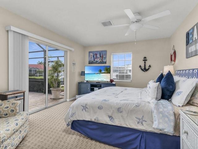 bedroom with access to exterior, multiple windows, light colored carpet, and ceiling fan