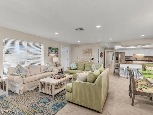 tiled living room with ceiling fan