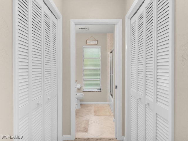 corridor with light tile patterned flooring