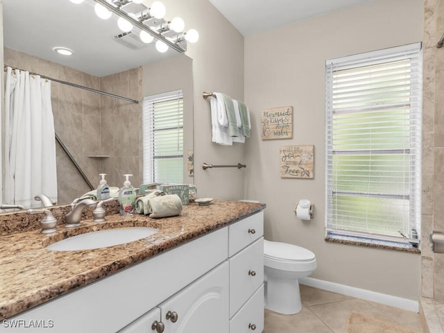 bathroom featuring toilet, vanity, tile patterned floors, and walk in shower