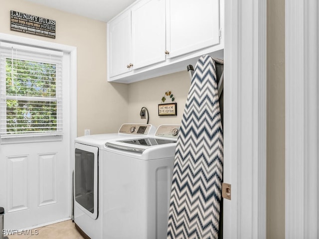 laundry area featuring cabinets, separate washer and dryer, and light tile patterned flooring