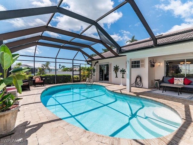 view of pool featuring outdoor lounge area, a patio, and a lanai