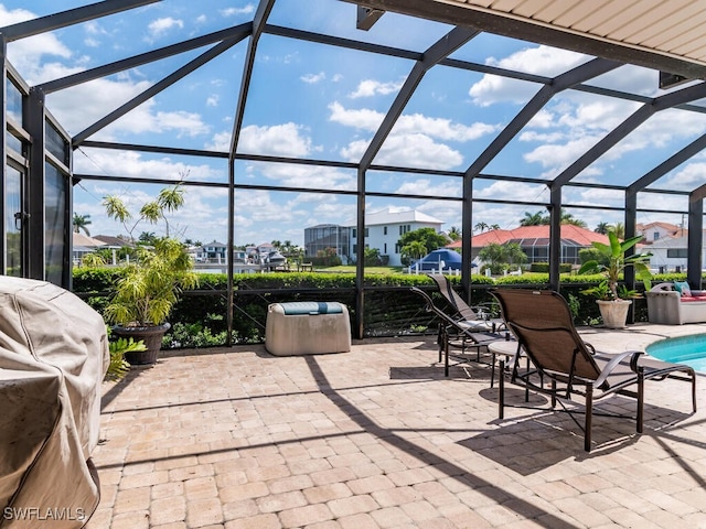 view of patio with a lanai and a grill