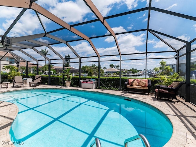 view of swimming pool with a lanai and a patio area