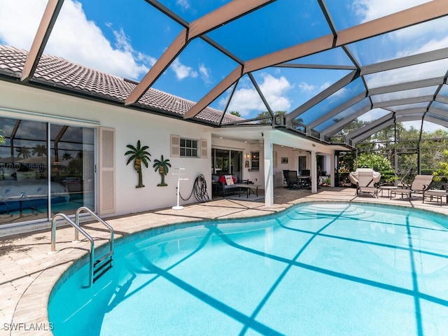 view of swimming pool featuring a patio and a lanai