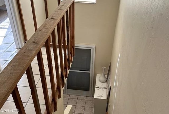 stairs with tile patterned floors