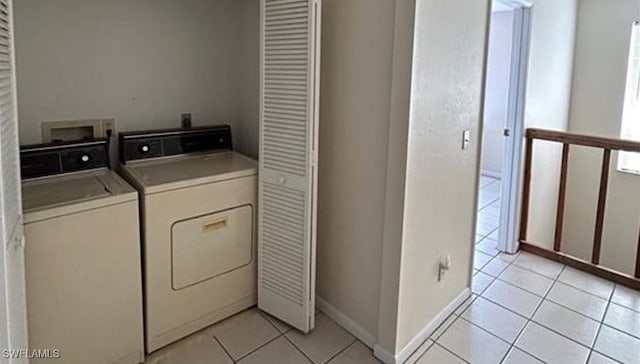 laundry room with washer and dryer and light tile patterned flooring