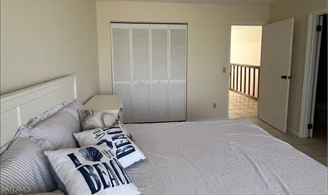 bedroom with a closet and light tile patterned floors