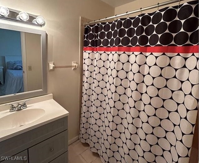 bathroom featuring tile patterned flooring, vanity, and walk in shower