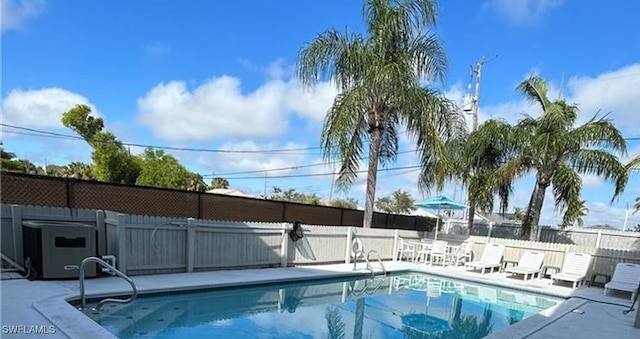 view of pool with a patio and central AC unit