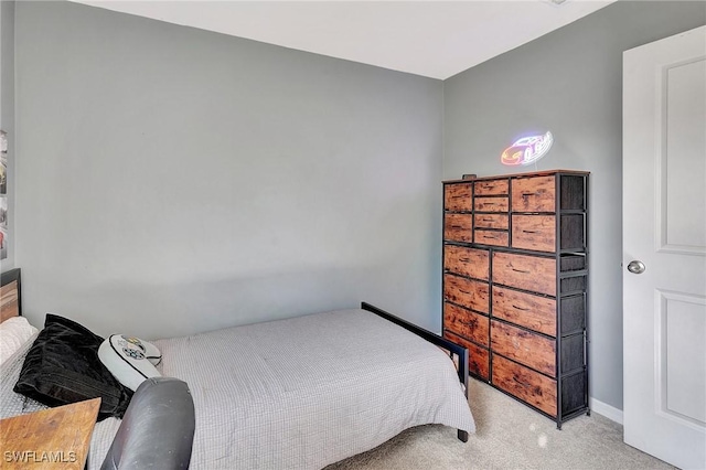 bedroom featuring light carpet