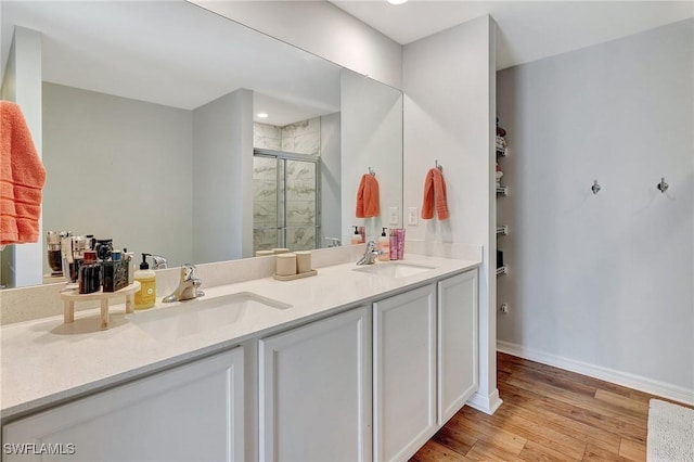 bathroom featuring vanity, a shower with shower door, and hardwood / wood-style flooring