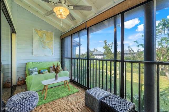 sunroom featuring ceiling fan and vaulted ceiling