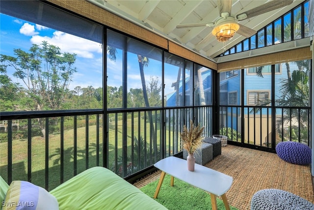 sunroom with ceiling fan and vaulted ceiling