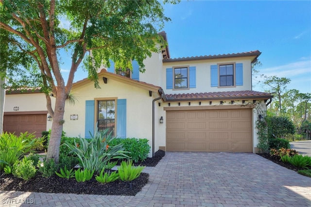 mediterranean / spanish home with a garage