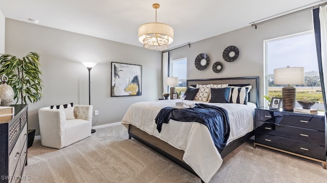 bedroom with an inviting chandelier, light carpet, baseboards, and multiple windows