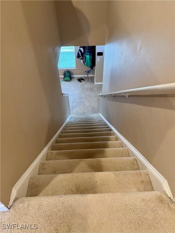 stairway featuring baseboards