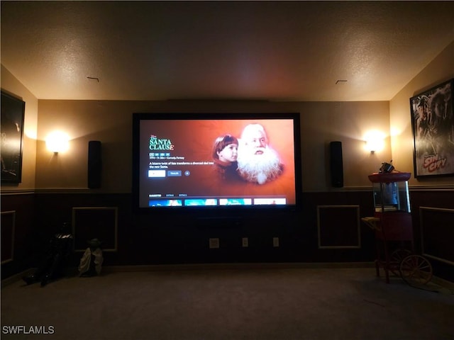 home theater featuring a textured ceiling and carpet floors