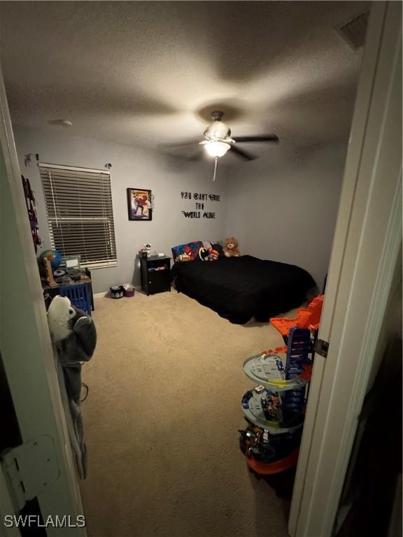 carpeted bedroom featuring a ceiling fan