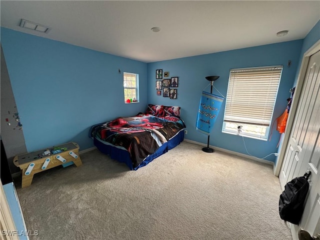 carpeted bedroom with visible vents and baseboards