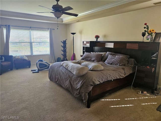 carpeted bedroom featuring ceiling fan, ornamental molding, a raised ceiling, and visible vents