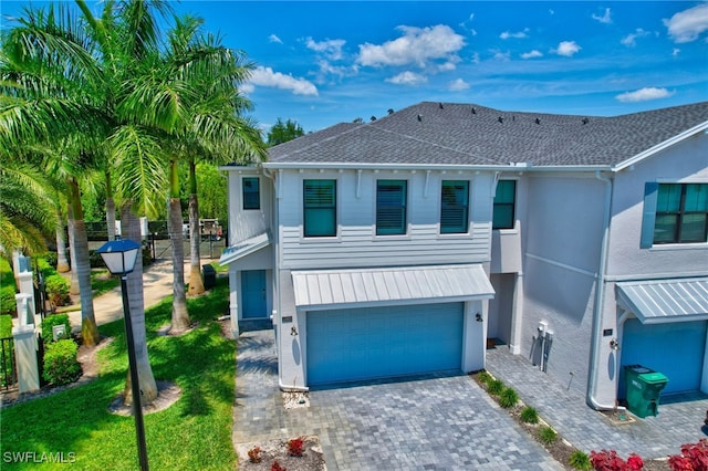 view of front of property with a front lawn and a garage