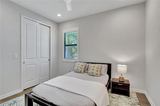 bedroom featuring wood-type flooring, a closet, and ceiling fan