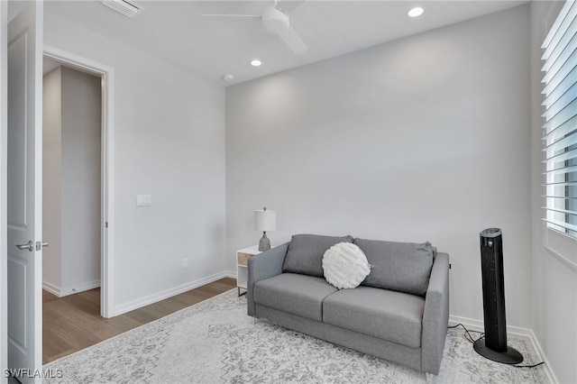 living room with ceiling fan and hardwood / wood-style floors