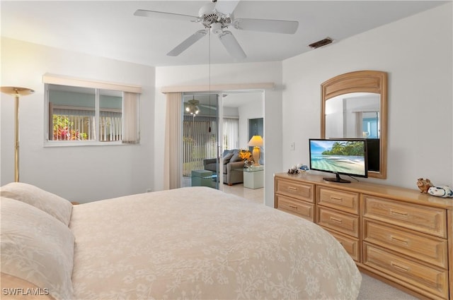 bedroom with ceiling fan, light colored carpet, and access to outside