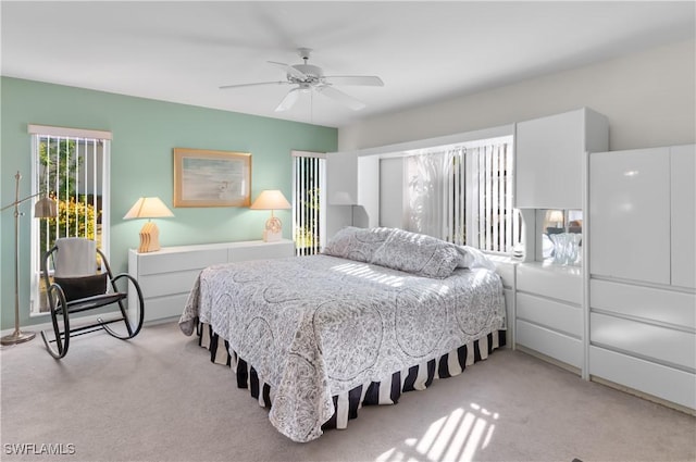 bedroom featuring light carpet and ceiling fan