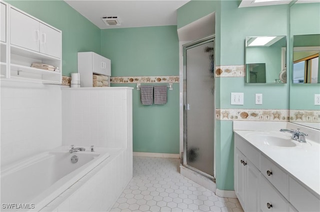 bathroom with tile patterned floors, vanity, and separate shower and tub