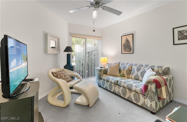 carpeted living room featuring ceiling fan