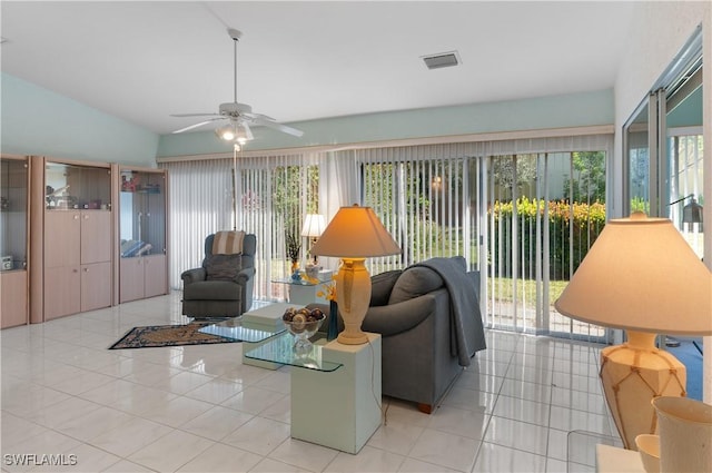 living room with ceiling fan, light tile patterned flooring, a healthy amount of sunlight, and lofted ceiling