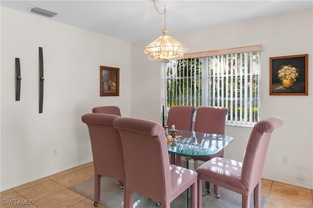 dining room featuring light tile patterned floors and an inviting chandelier