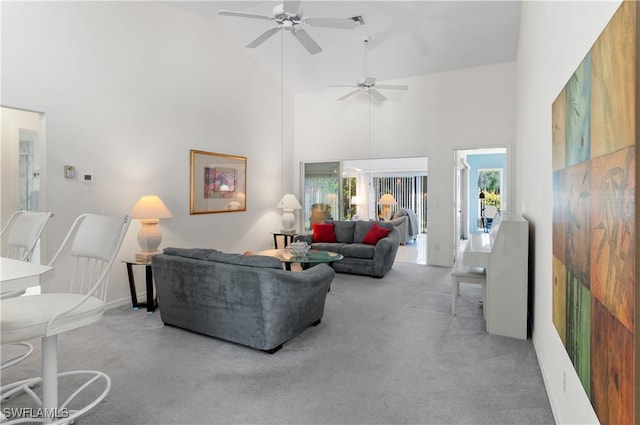 carpeted living room with high vaulted ceiling and ceiling fan