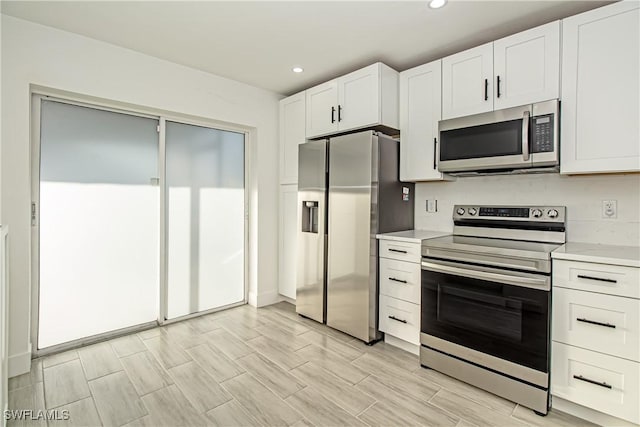 kitchen with appliances with stainless steel finishes and white cabinets