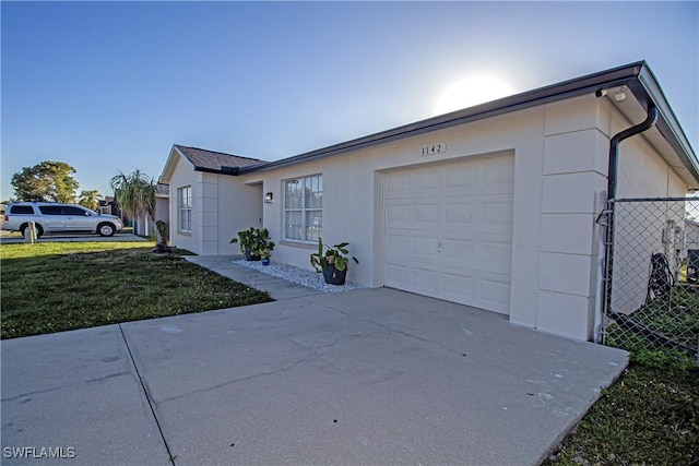 exterior space with a garage and a front lawn