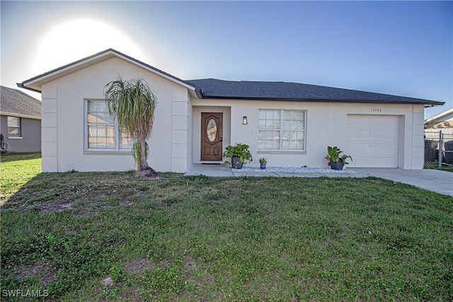 ranch-style home with a garage and a front lawn