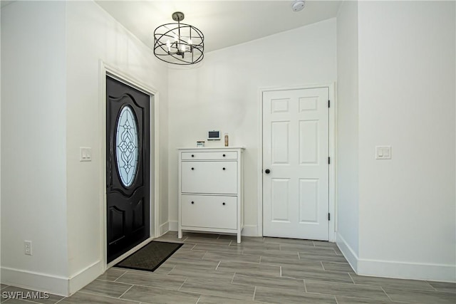 foyer entrance with a notable chandelier