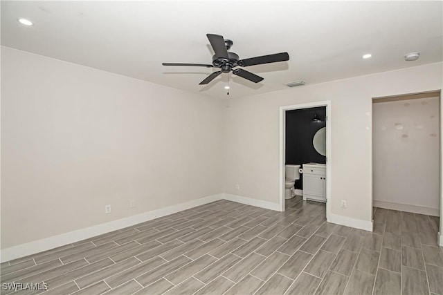 unfurnished bedroom with light hardwood / wood-style floors, ceiling fan, and ensuite bathroom