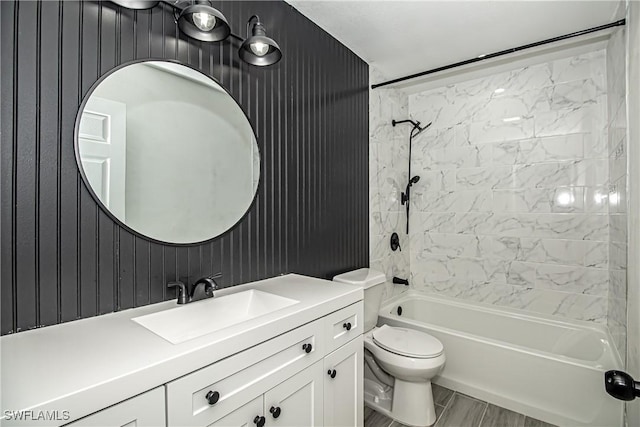 full bathroom with vanity, toilet, and tiled shower / bath