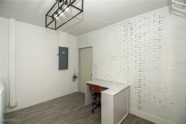 unfurnished office with brick wall and electric panel