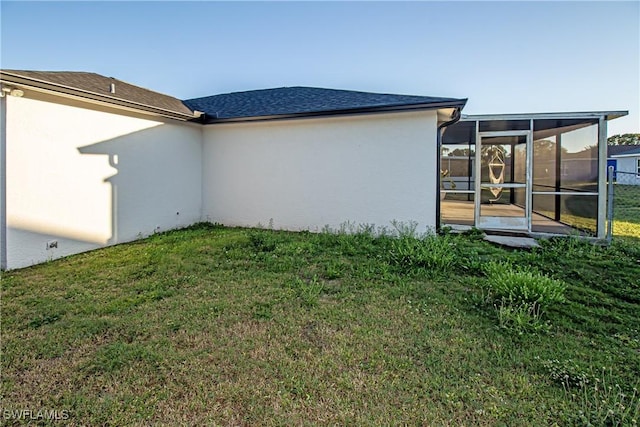 exterior space with a sunroom and a yard