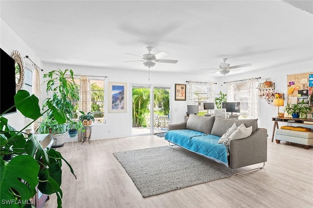 living room featuring light hardwood / wood-style floors and ceiling fan