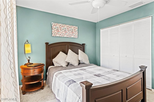 carpeted bedroom with a closet and ceiling fan